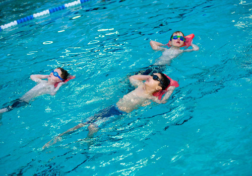 A photo swimming the breast stroke in a public pool