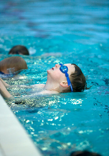 A photo swimming the breast stroke in a public pool